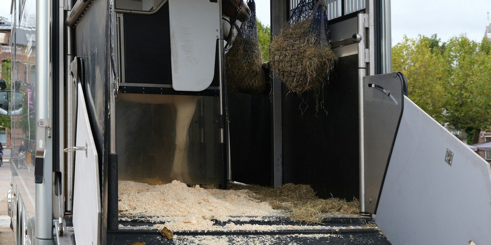 a horse trailer with hay inside of it